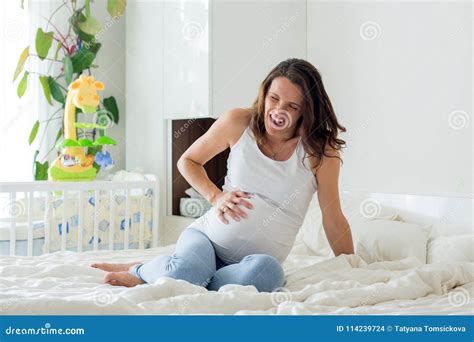 Young Beautiful Pregnant Woman In Pain With Labor Contraction Stock