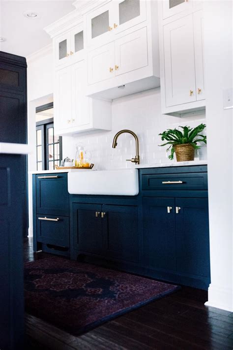 Try using gold hardware like this to tie the varied elements together. Contemporary Kitchen With Navy Blue Base Cabinets And White Upper Cabinets | HGTV