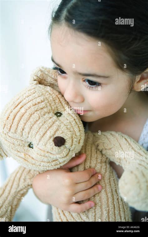 Little Girl Holding Teddy Bear Looking Away Portrait Stock Photo Alamy