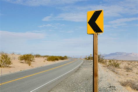 Turn Ahead Sign Along Remote Desert Road By Stocksy Contributor