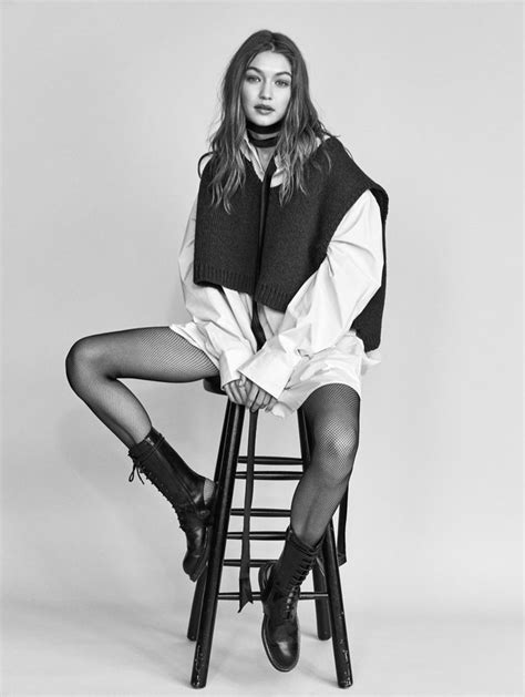 A Woman Sitting On Top Of A Wooden Chair Wearing Boots And A Sweater