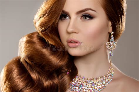 model with long red hair waves curls hairstyle hair salon updo fashion model with shiny hair