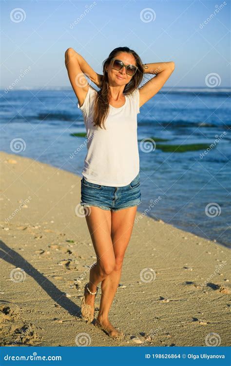 Slim Young Woman Walking Barefoot Along The Beach Caucasian Woman