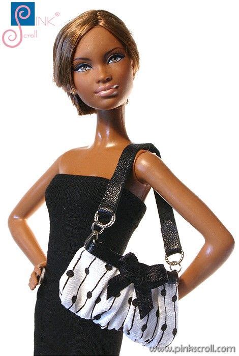 A Barbie Doll Wearing A Black And White Dress With A Purse On Its Shoulder