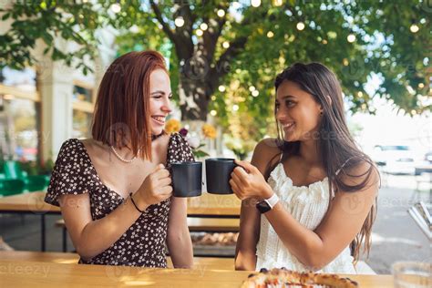 Two Friends Drinking Coffee Women Clinking With Cups Of Coffee