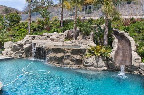 Rock Swimming Pool With A Water Slide Spa Waterfalls And A Cave