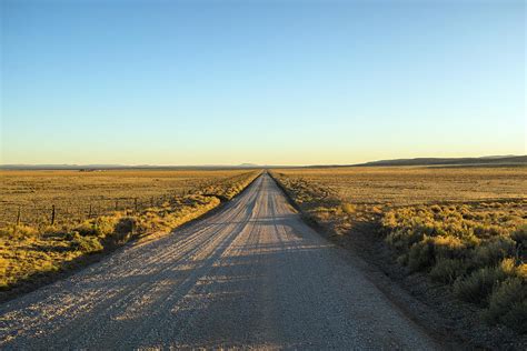 Empty Gravel Dirt Road In The Desert Photograph By Ron Koeberer