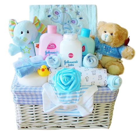 The set comprises large muslin cloth for swaddling, baby socks, cotton bodysuit with envelope neck, cotton bib, baby shampoo, baby soap, baby lotion. Luxury Baby Gift Basket for a Boy