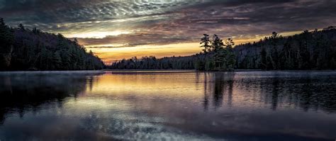 2560x1080 A Calm Lake At Sunset 2560x1080 Resolution Wallpaper Hd