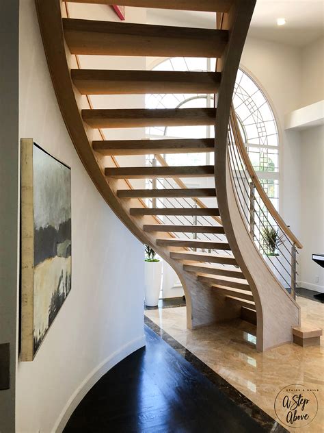 Curved Wood Staircase With Open Treads And Stainless Bars — A Step