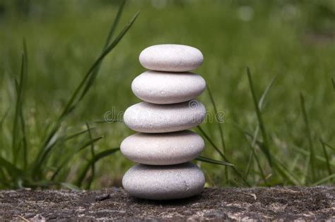 Harmony And Balance Simple Pebbles Tower In The Grass Simplicity
