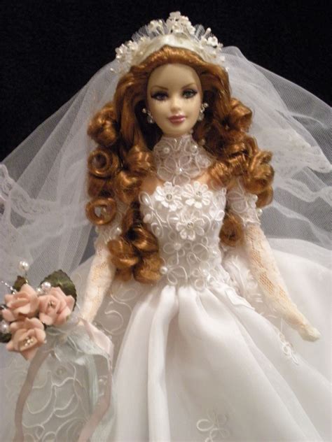 The Doll Is Wearing A Wedding Dress And Holding A Flower In Its Hand