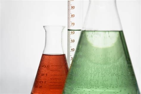 Two Clear Measuring Beakers With Liquids Hd Wallpaper Wallpaper Flare