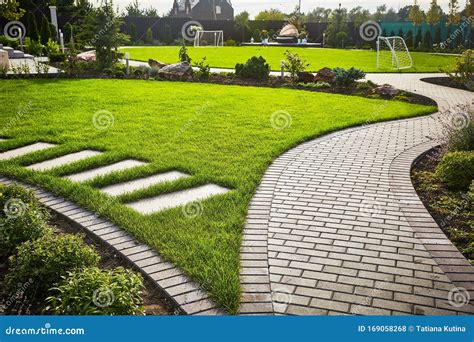 Landscaping Of The Garden Path Curving Through Lawn With Green Grass