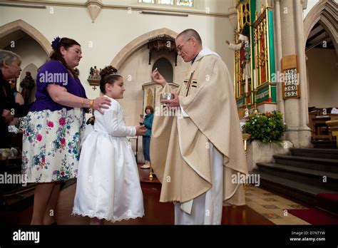 Catholic Girl Makes Her First Holy Communion Stock Photo Alamy