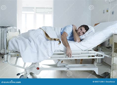 Desperate Man At Hospital Bed Alone Sad And Devastated Suffering