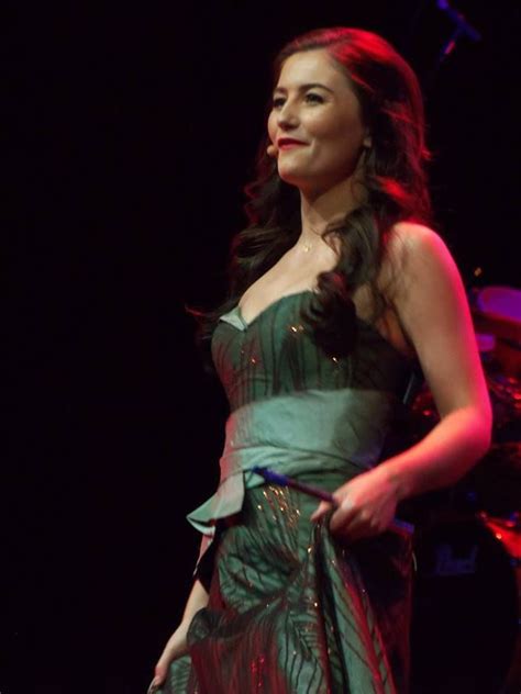 A Woman In A Green Dress On Stage