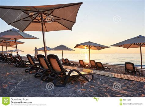 Scenic View Of Sandy Beach On The Beach With Sun Beds And Umbrellas Open Against The Sea And