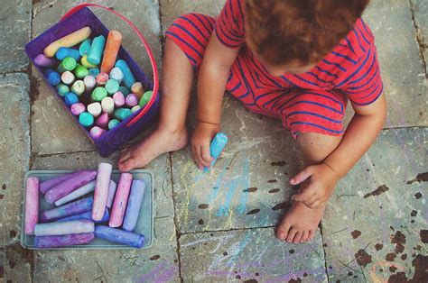 A Young Boy Drawing With Chalk By Stocksy Contributor Chelsea
