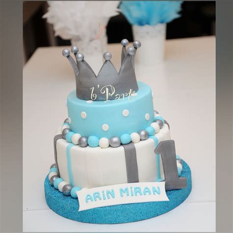 Cute one year old baby boy having a home party with birthday cake. Baby boy cake. First birthday cake. Regalia cake. Prince ...