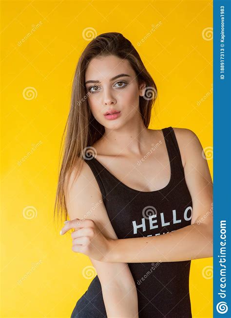 girl on a yellow background portrait of a beautiful brunette girl on a bright background stock