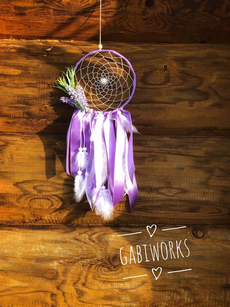 A Purple Dream Catcher Hanging On A Wooden Wall