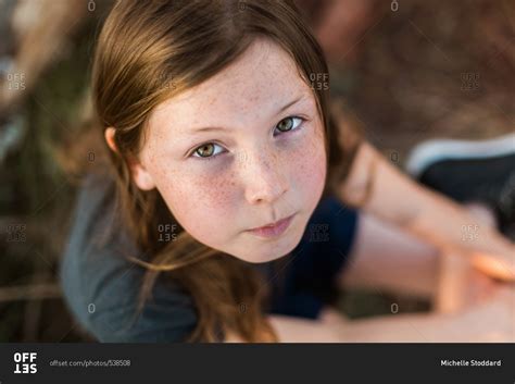 Have tons of freckles and green eyes! Girl with hazel eyes and freckles stock photo - OFFSET