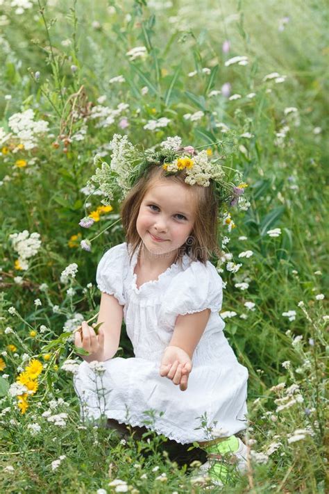 Little Girl Sniffs Wildflowers On A Meadow Stock Image Image Of Head