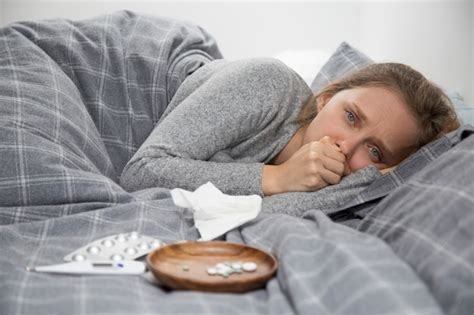 Free Photo Sick Young Woman Lying In Bed Coughing