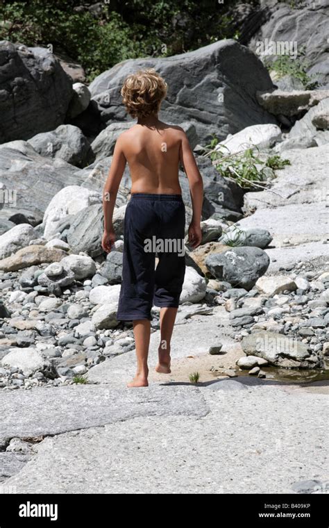 Barefoot Boy Walking On Rocks Stock Photo Alamy