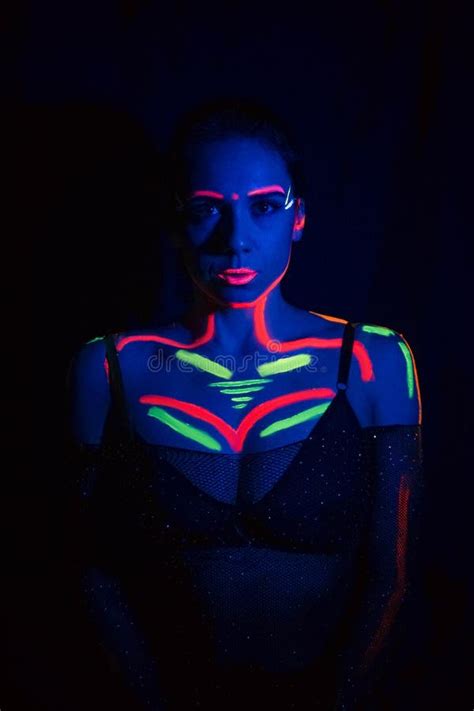 fashion model woman in neon light portrait of a beautiful model with fluorescent makeup body