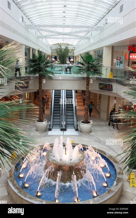 Interior Of Shopping Mall With Water Fountain Escalators And Skylight