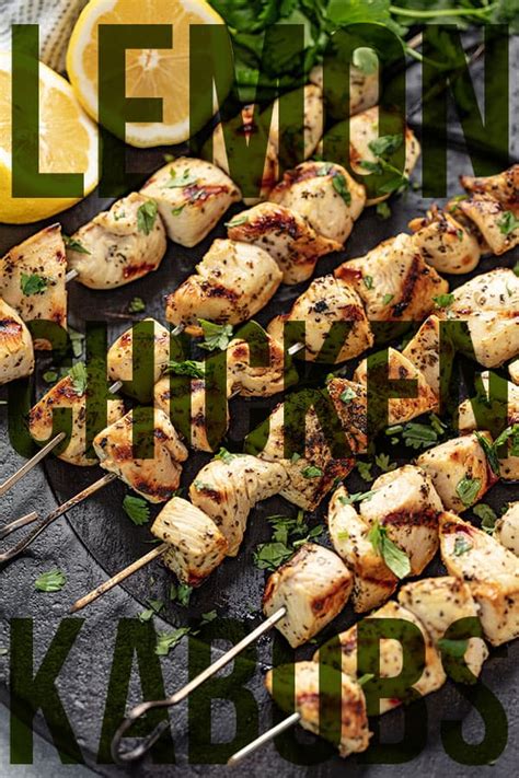 Chicken Kabobs On Skewers With Lemon And Parsley Garnish