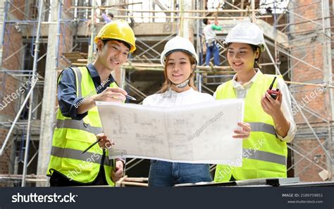 Team Construction Inspector Explaining Building Process Stock Photo