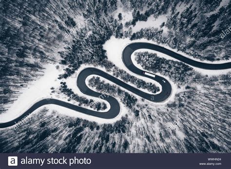 Winding Road In A Forest Covered With Snow Stock Photo Alamy