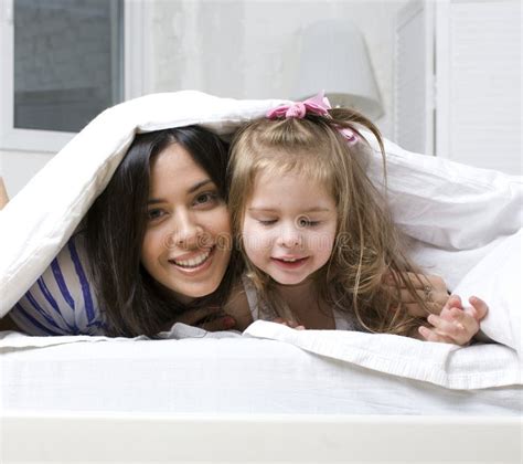Portrait Of Mother And Daughter Laying In Bed And Smiling Stock Image Image Of Lying Human