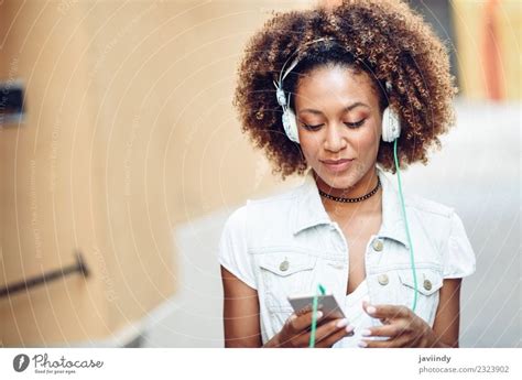 Black Woman Listening To The Music With Headphones A Royalty Free