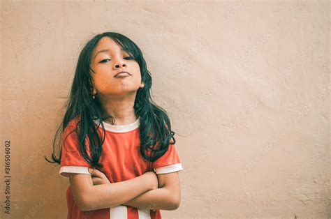 Portrait Of An Asian Little Girl With Long Wavy Hair And Wearing A
