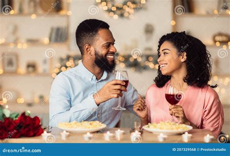 Happy Black Woman And Man Drinking Wine And Laughing Stock Photo