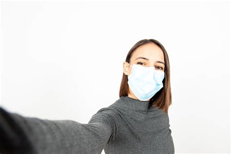 Hispanic Girl With A Face Mask During Pandemic Stock Photo Download