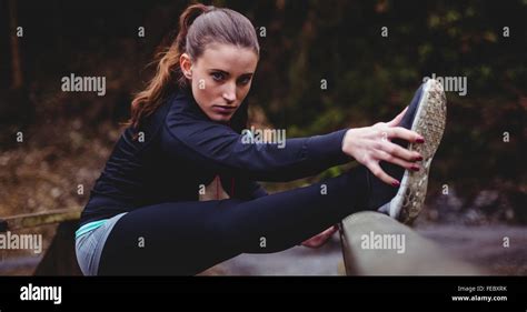 Fit Brunette Stretching Her Legs Stock Photo Alamy