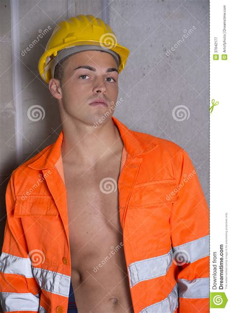 Handsome Young Construction Worker With Orange Suit And Hardhat Stock