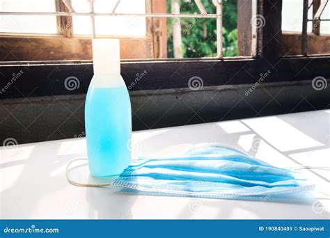 Hand Sanitizer Alcohol Gel And Surgical Mask Placed On The Table Stock
