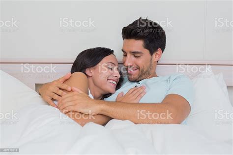 Attractive Couple Cuddling In Bed Stock Photo Download Image Now 20