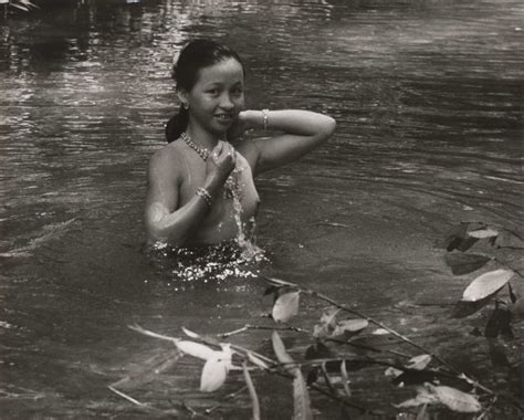A Woman In The Water With Her Arm Around Her Neck
