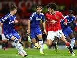 Marouane Fellaini Of Manchester United Competes With Gary Cahill Of