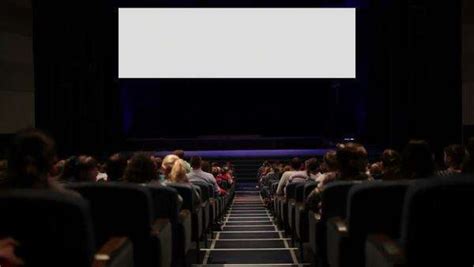 White Cinema Screen With Projector Light And Audience In A Modern