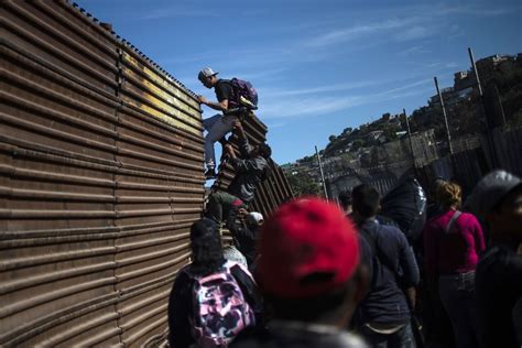 Migrants In Tijuana Run To Us Border But Fall Back In Face Of Tear
