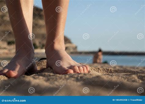 Closeup Of A Woman S Legs And Feet With Nail Polish On The Sand In A