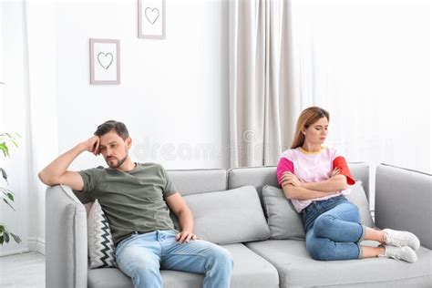 Couple Ignoring Each Other After Argument In Living Room Stock Photo